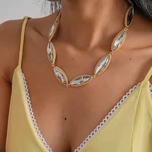 Detailed close-up view of a luxury gold necklace with marquise-cut clear crystals