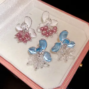 Elegant enamel flower stud earrings featuring pink pearls and clear crystals in a box