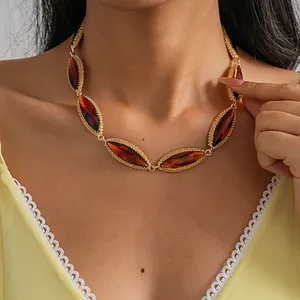 Close-up of luxury marquise rhinestone necklace with gold-plated geometric link detail.