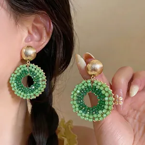 Elegant green beaded circular dangle earrings with gold textured studs for women