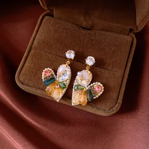 Elegant vintage heart-shaped drop earrings featuring colorful crystals in a velvet gift box