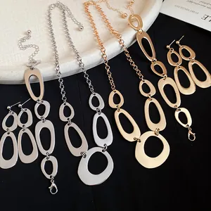 Close-up of elegant gold and silver irregular circular link necklace and earring set