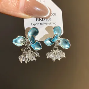 Elegant blue enamel flower stud earrings featuring crystal beaded tassels and silver posts.