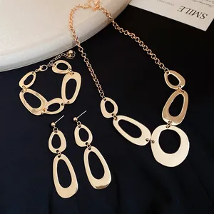 Detail of elegant gold irregular oval jewelry set including necklace, bracelet and earrings