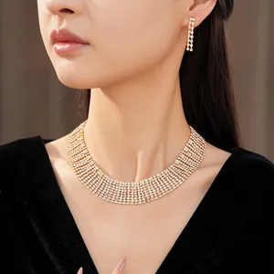 Close-up view of elegant rhinestone fringe necklace and earring set on a female model