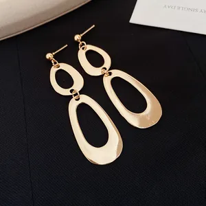 Macro view showing the polished finish of gold irregular oval drop earrings for women