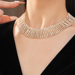 Detailed view of a luxurious multi-layer gold rhinestone choker necklace on a model's neck.