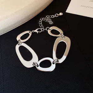 Detailed close-up view of a silver irregular hollow oval link chain bracelet for women