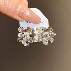 Orecchini a lobo a fiore in argento con cristalli scintillanti e design floreale romantico.