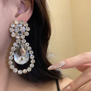 Close-up detail of luxury silver teardrop earrings adorned with sparkling clear crystals