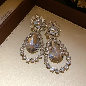 Macro view showing the fine detail of elegant waterdrop earrings with clear crystals