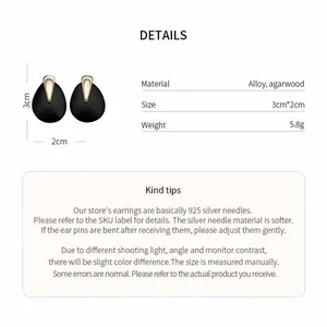 Detailed specs of minimalist black water drop earrings with gold accents and 925 silver needles.