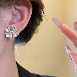 Primo piano di un orecchino a fiore in argento con petali di cristallo scintillanti