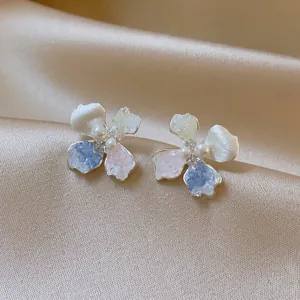 Detailed view of elegant silver flower stud earrings with colorful petals and central pearls