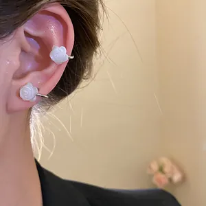 Close-up of elegant 18k gold plated white mother-of-pearl rose flower ear cuffs