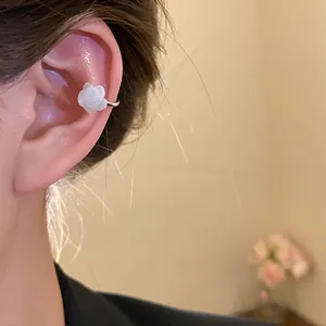 Detailed macro view of a vintage white mother of pearl rose flower ear cuff earring