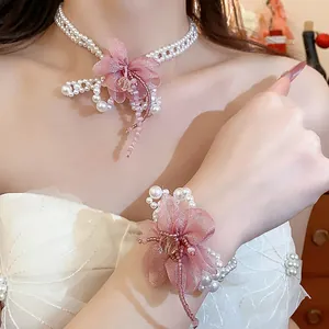 Exquisite detail of pink chiffon flower and pearl necklace with matching bracelet