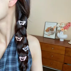 Detailed view of sweet hollow butterfly hair clips worn on a dark braided hairstyle