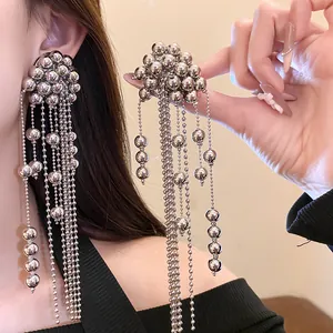Detailed close-up showing elegant silver beaded tassel earrings worn by a female model