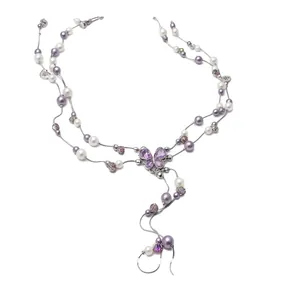 Elegant pearl necklace featuring a purple crystal butterfly pendant and stylish tassels.