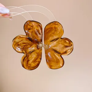 Detailed macro view showing the amber resin texture and golden center of this flower earring