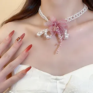 Elegant chiffon flower pearl necklace with sweet style beaded details shown on model.