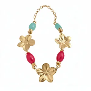Vintage style gold-toned metal flower pendant necklace with turquoise and red resin beads