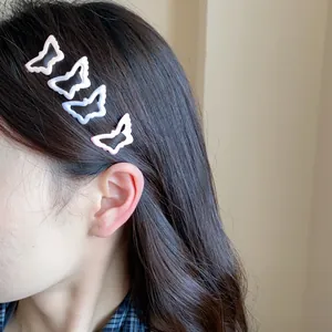 Sweet pastel butterfly-shaped oil-dripping BB hair clips shown on dark wavy hair