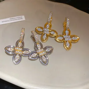 Vue détaillée de boucles d'oreilles fleur en plaqué or 18 carats et argent avec zircons