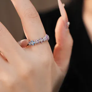 Close-up of a delicate colorful zircon floral ring on finger for a niche luxury look