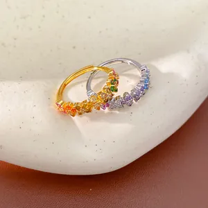Macro detail showing colorful rainbow cubic zirconia stones on gold and silver rings