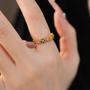 Close-up of elegant gold ring featuring colorful zirconia flower clusters