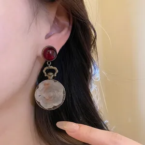 Elegant vintage bronze earrings featuring red round studs and white resin flower charms
