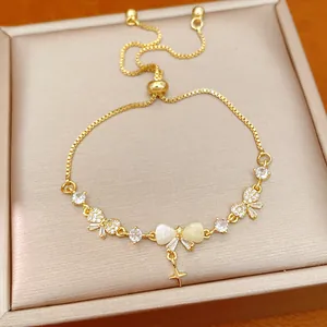 Close-up of 18K gold-plated adjustable bracelet with zircon bow and star charms