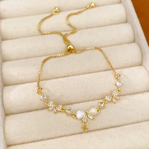 Detailed view of 18K gold plated bow and star bracelet with sparkling zircon inlays