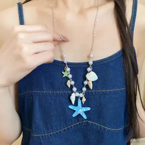 Elegant summer ocean starfish and shell pearl necklace worn on model showing details