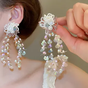 Close-up detail of sweet dopamine flower tassel earrings with iridescent sequins and pastel beads