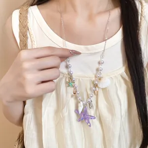 Close-up of summer starfish and shell necklace with pearls for beach vacation style