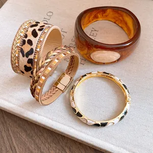 Detailed view of mixed vintage bracelets including leopard print and amber resin