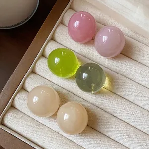 Minimalist dopamine-colored round resin ball stud earrings displayed in jewelry box