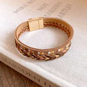 Macro detail of multi-strand Maillard braided leather bracelet with golden magnetic clasp