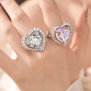 Close-up detail of two elegant heart-shaped zircon rings with shimmering stone halo