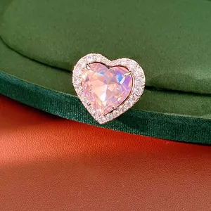 Detailed macro view of an exquisite pink heart zircon ring with diamond-studded halo