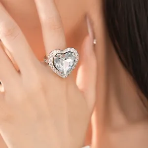 Close-up of elegant heart-shaped zircon ring with pavé-set stones on model's hand