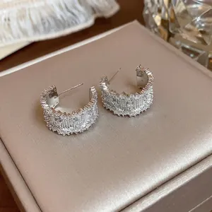 Elegant silver needle C-shaped hoop earrings with sparkling micro-pave zircons.