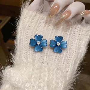 Elegant blue cat's eye stone flower stud earrings with a central sparkling zircon.