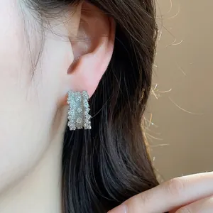 Elegant C-shaped silver stud earrings with sparkling zircon stones for women's jewelry.