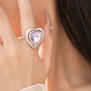 Detailed close-up view of heart-shaped pink zircon ring with diamond-set pavé halo