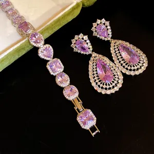 Detailed macro view of luxury purple zirconia drop earrings and matching bracelet set