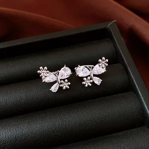 Elegant silver zircon butterfly non-piercing ear clips presented in a luxury black jewelry box